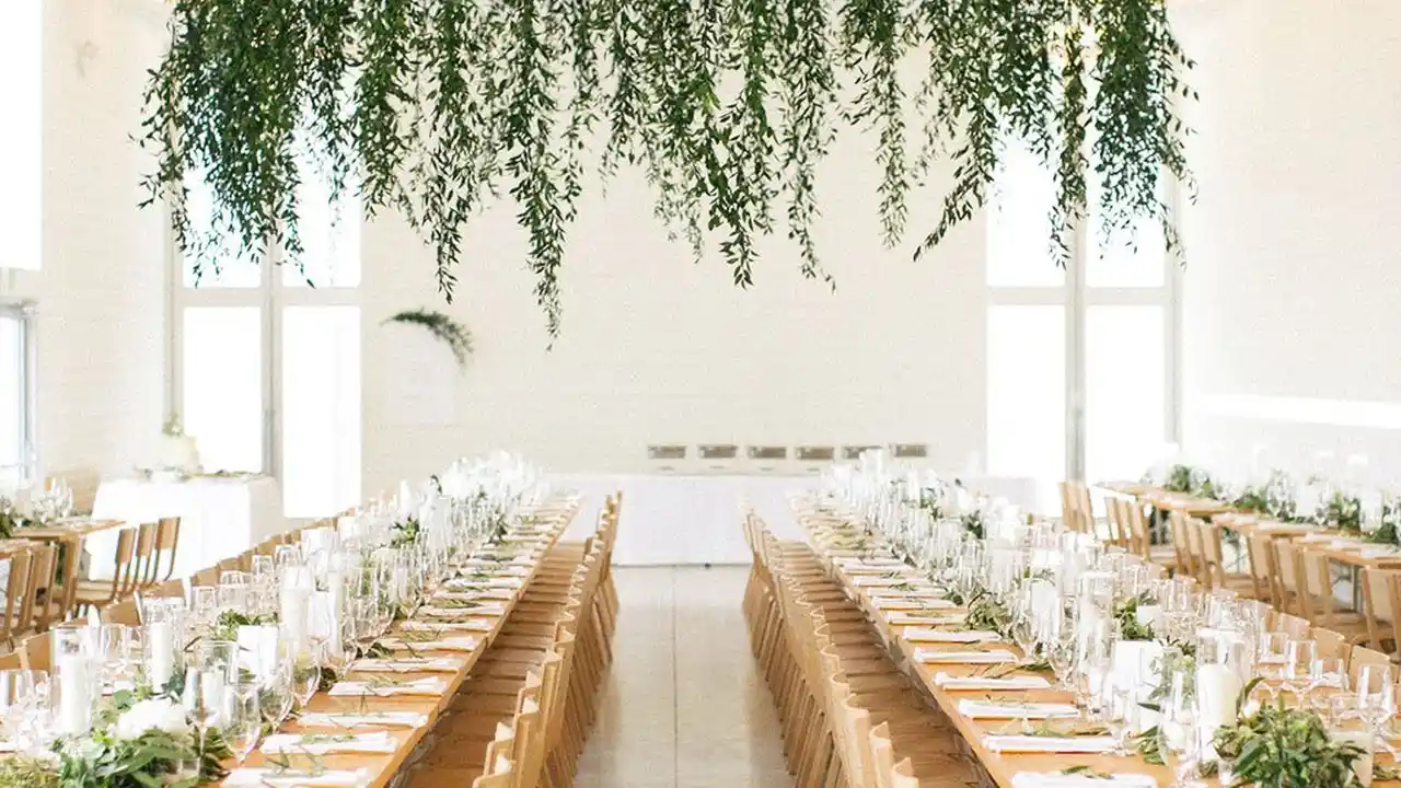 blue bowl of black bean beef tortilla soup on a board with cilantro and shredded cheese in background