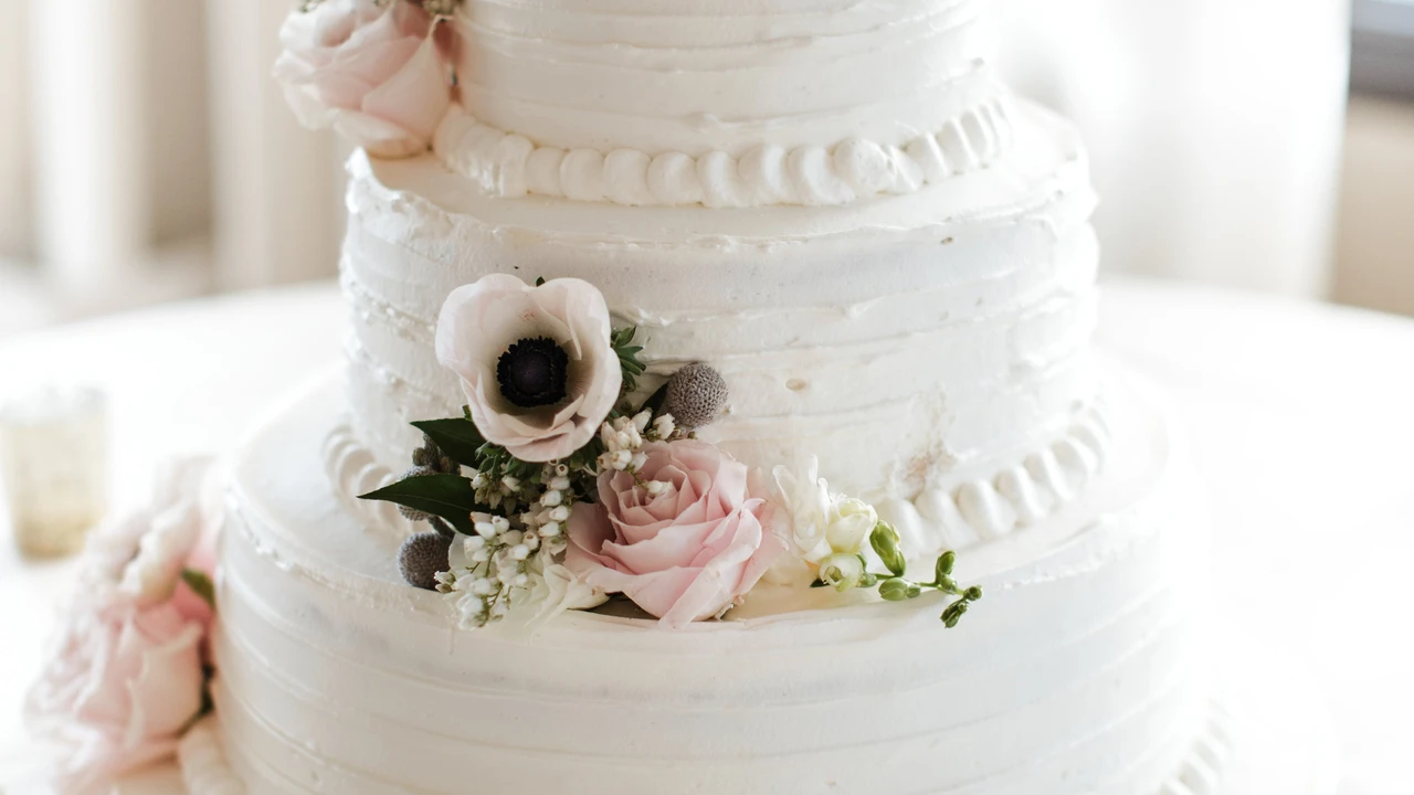 blue bowl of black bean beef tortilla soup on a board with cilantro and shredded cheese in background