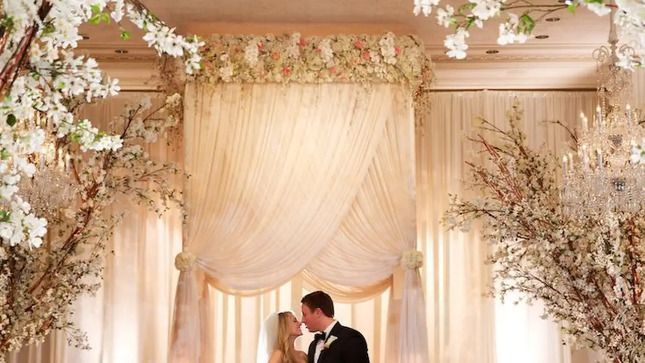 blue bowl of black bean beef tortilla soup on a board with cilantro and shredded cheese in background